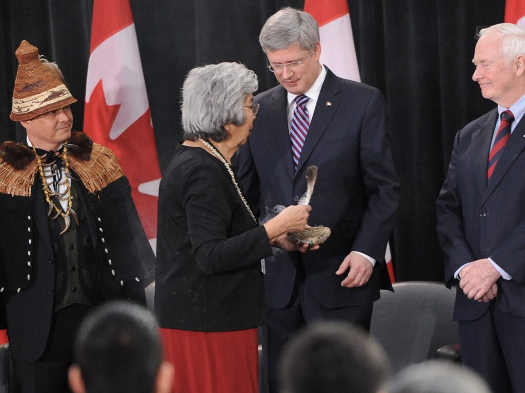 Crown-First Nations Gathering, with the late Elder Bertha Commonda smudging Prime Minister Harper along with National Chief Shawn Atleo and Governor General David Johnston.